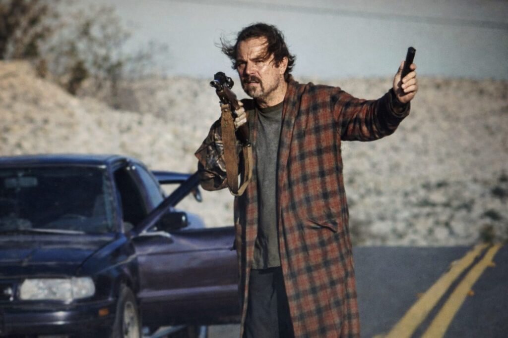 Leonardo DiCaprio action scene from One Battle After Another movie on desert road