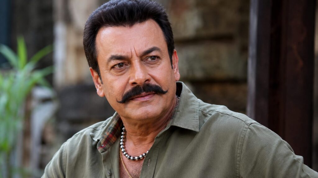 Alt Text Veteran Bollywood actor Pradeep Rawat in a casual green shirt looking away from the camera.

